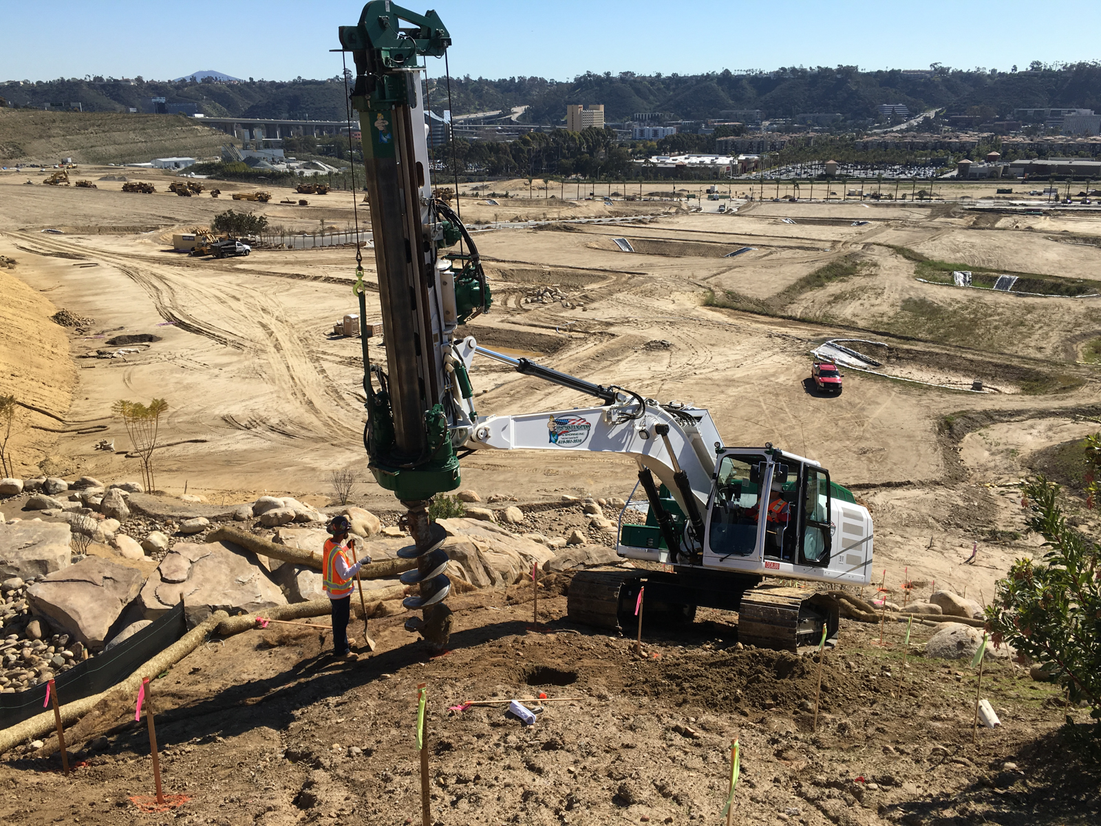 Our limited access "Baby" drill boring a hole for a caisson at the top of a hard-to-reach dirt slope in San Diego, CA.