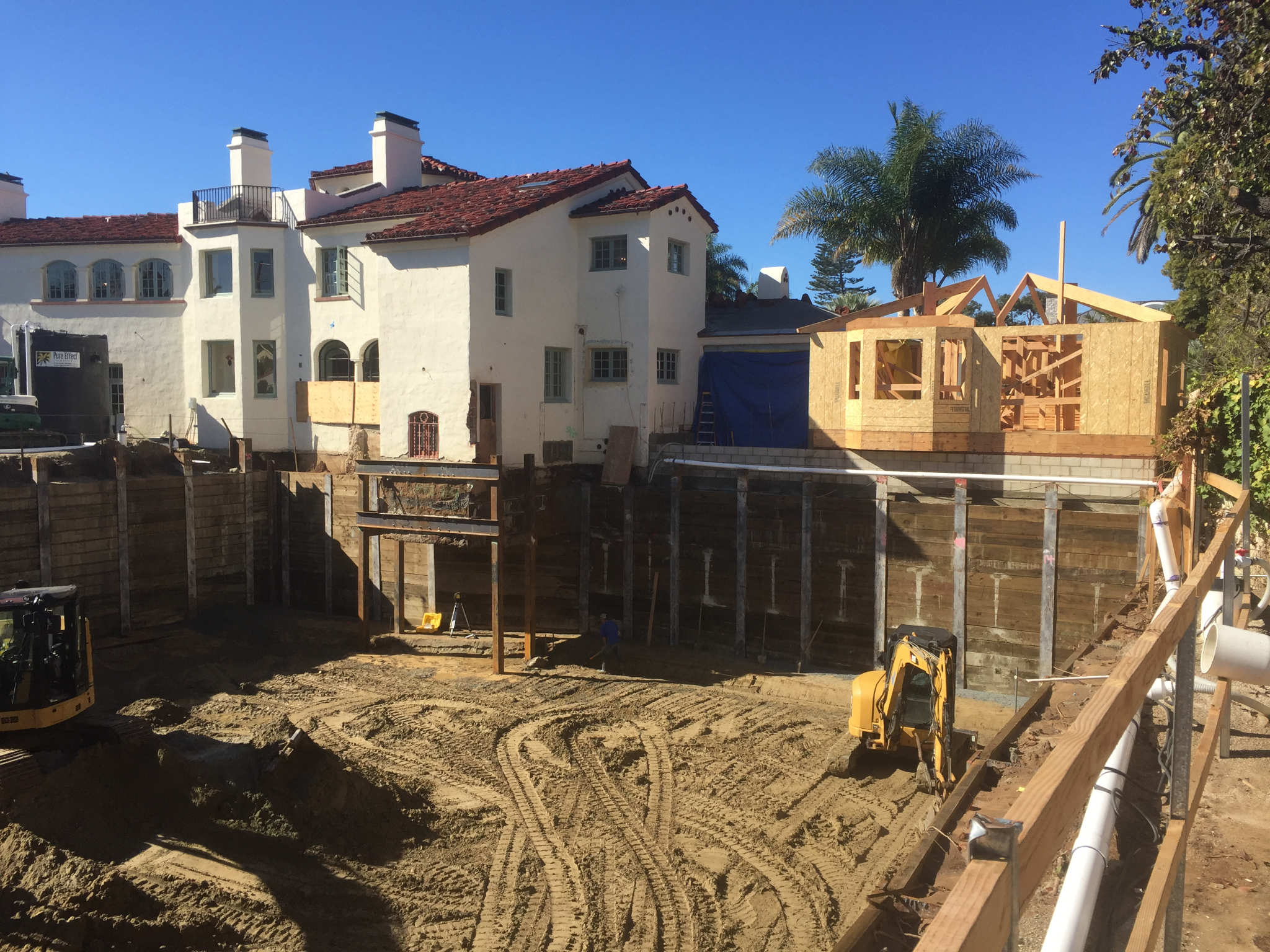 Temporary shoring and underpinning system set up to support a historic house in Coronado, CA during a basement addition.