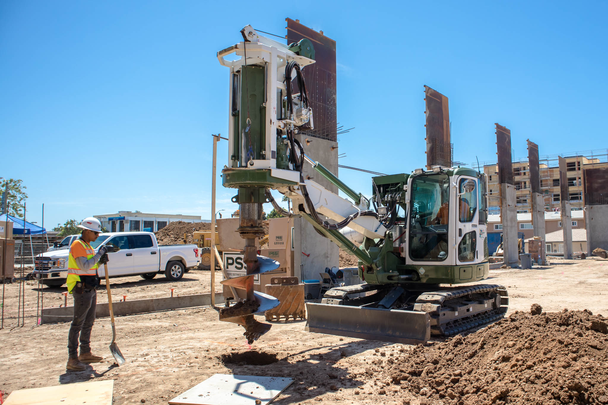 A drill rig bores a shaft, which will later be backfilled with concrete to provide a firm foundation.